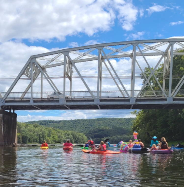 People floating and kayaking on the Juniata River.